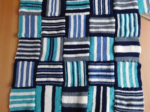 Christine C. Knee blanket, stripey squares, knitted.